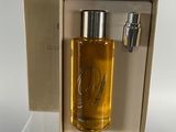 a bottle of perfume in a box on a table