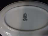 a white plate with a black and white logo on it