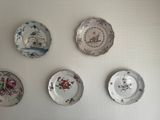 four plates on the wall that have different designs on them