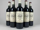 four bottles of wine are lined up in a row
