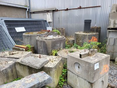 many concrete blocks that have been left out in the yard