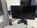a computer monitor, keyboard and mouse on a desk