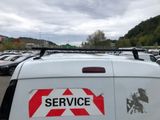 cars parked in a parking lot with a service sticker on the side of the van
