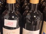 many bottles of wine sitting on a shelf in a store