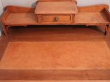 a wooden desk with a drawer on top of it