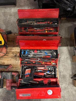 many tools in a red toolbox on a pallet