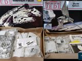 two boxes of star wars memorabilia sitting on a table