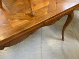 a wooden table with two chairs on top of it