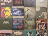many different album covers on the wall of this room
