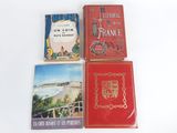 several books are sitting on a table with a white background