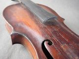 a close up of a violin that is on a table