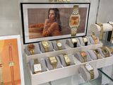 many watches on display in a glass display case