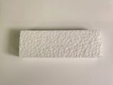 a close up of a piece of white paper on a white surface