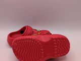 a close up of a pair of red shoes on a white surface