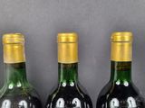 three bottles of wine that are sitting on a table