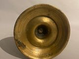 a small gold vase sitting on a white surface