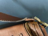 the inside of a brown leather bag with a zipper on it