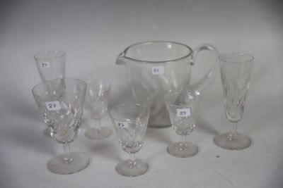 a lot of glasses and a pitcher sitting on a table