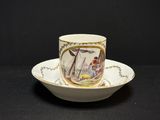 a cup and saucer with a picture of a boat on it