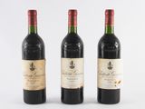 three bottles of wine sitting next to each other on a white surface