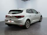 the rear end of a silver car in a white room