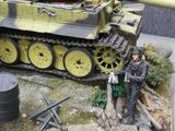 a model of a tank with a man standing next to it