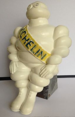 a statue of a man with a sash sitting on a table