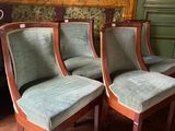 four chairs that are sitting on a rug in a room