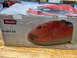 a box that has a red mouse in it on a table