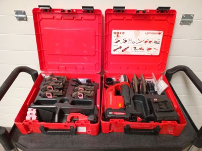two red tool boxes with tools in them sitting on a cart