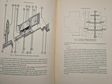 an open book with a drawing of a machine on it