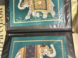 two pictures of an elephant painted on the back of a wallet