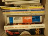 many books stacked on top of each other in a box