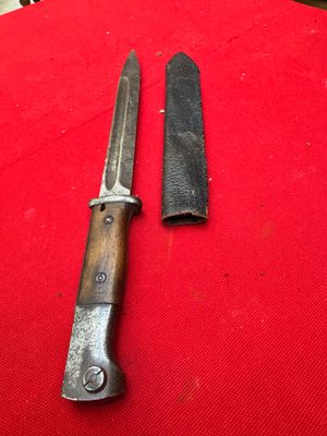two knives are sitting on a red cloth on a table