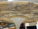 a marble table with a white base in a room