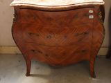 a small chest of drawers in the corner of a room