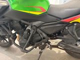 a green and yellow motorcycle parked in a garage