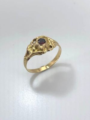 an image of a gold ring with a stone in the middle
