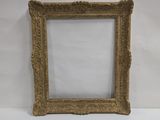 an old picture frame sitting on top of a white surface