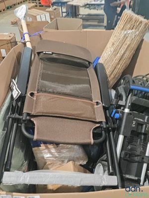 a cardboard box with a chair in it and a broom in it