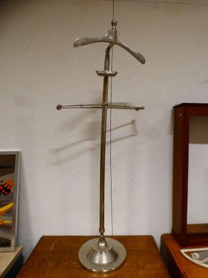 a metal object on a wooden table next to a mirror