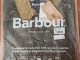 a barbour shirt wrapped in plastic on a table