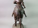 bronze statue of a knight on a horse with a sword
