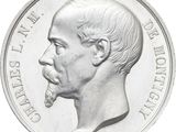 a close up of a silver coin with a man ' s face on it