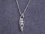 a close up of a silver necklace with a flower on it