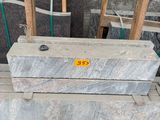 a close up of a pile of wooden pallets sitting on top of a wooden floor