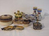 many different types of pottery sitting on a table
