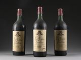three bottles of wine are lined up on a table