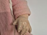 a doll of a person holding a baby in her arms