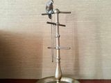two birds sitting on top of a stand on a table